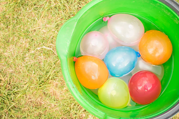 istock bucket with water balloons. 912146356
