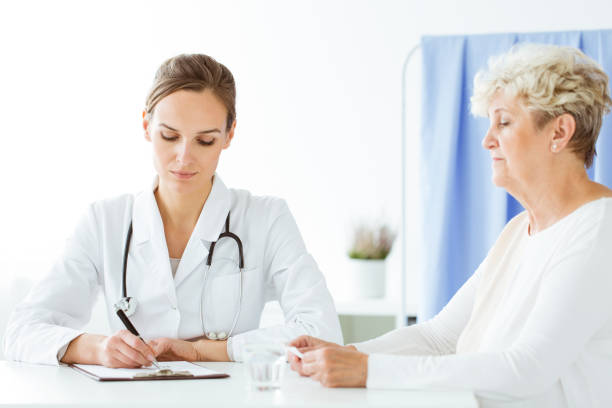 istock Doctor with stethoscope writing prescription 912150860