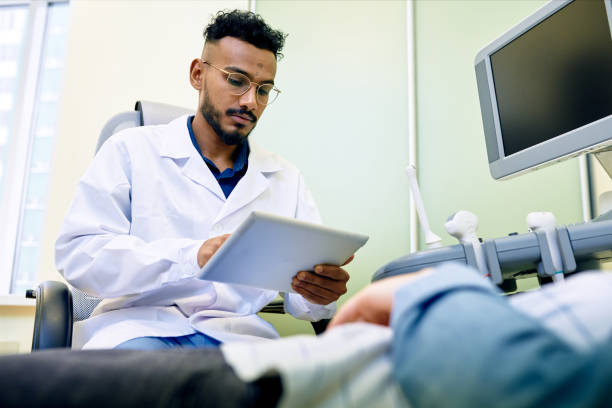 istock Confident doctor using tablet at consultation with patient 912150904