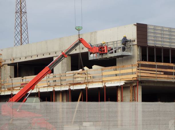 istock Building activity. Cherry pickers at work on a facade of a new construction building 912152082