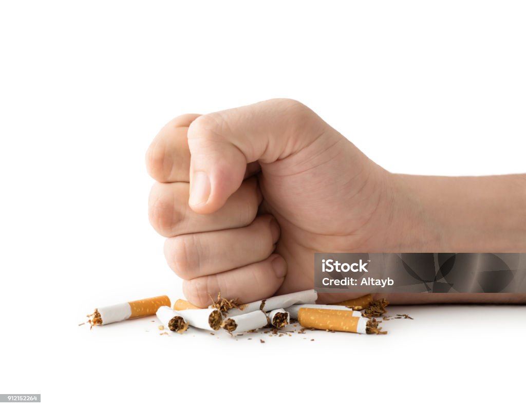 Quit Smoking Man fist destroying cigarettes , isolated on white Quitting Smoking Stock Photo