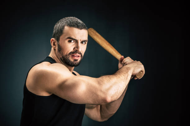 istock sportive man with baseball bat 912152586