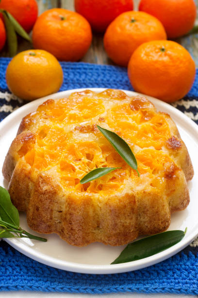 istock Mandarin cake and tangerines on rustic background. 912158670