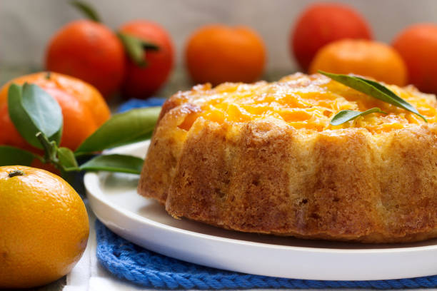 istock Mandarin cake and tangerines on rustic background. 912161834