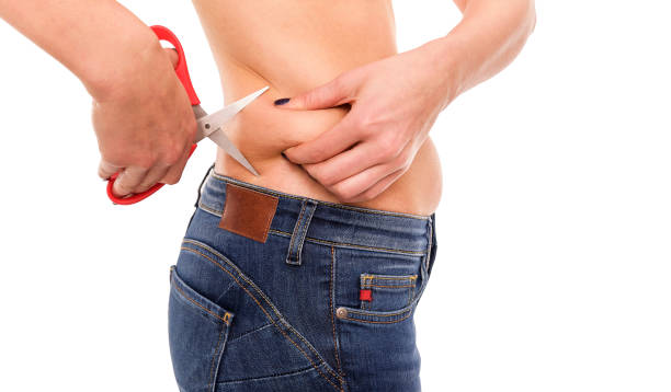 istock Scissors cut off excess fat at the waist. 912163900
