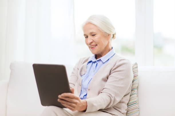 istock happy senior woman with tablet pc at home 912166872