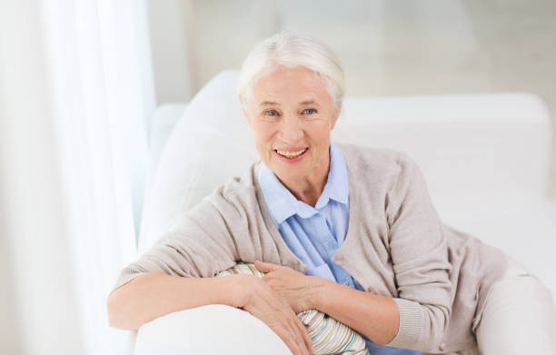 istock happy senior woman face at home 912168076