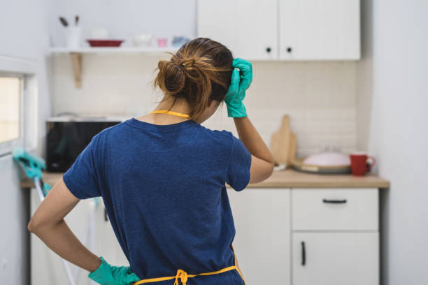 istock Tired young woman standing at kitchen room 912170568