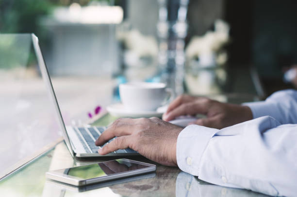 istock attractive business man hand using laptop working with coffee cup in coffee shop. 912170570