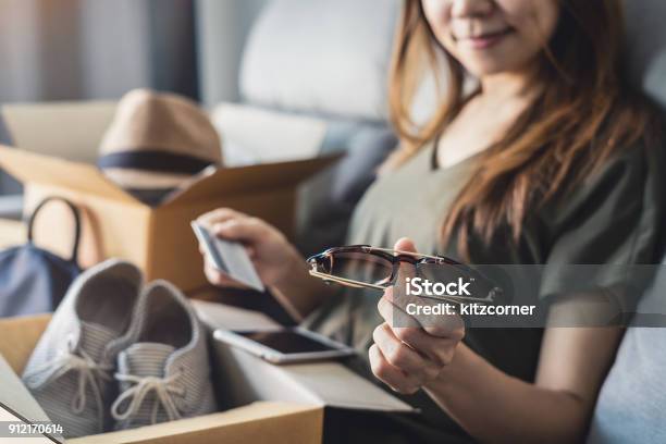 Young Woman Received Online Shopping Parcel Opening Boxes Stock Photo - Download Image Now