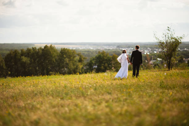 istock couple bride and groom on field background 912171864