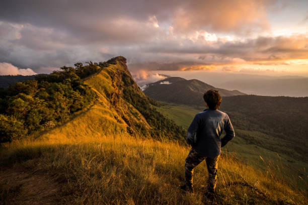 istock Young traveler looking at beautiful sunrise over the mountain 912172000