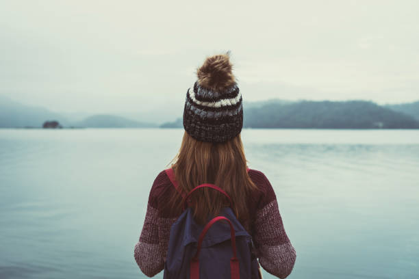 istock Lonely woman standing absent minded and looking at the river 912172096
