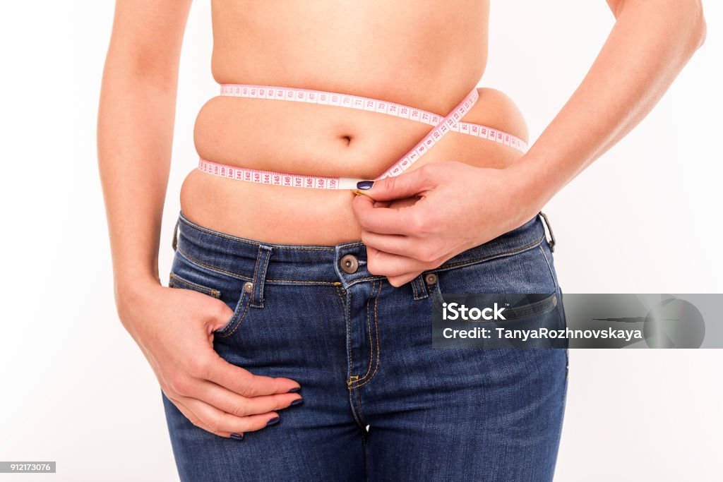 Fat on the abdomen. Fat on the abdomen. Fighting overweight. Female silhouette isolated on white background. Abdomen Stock Photo