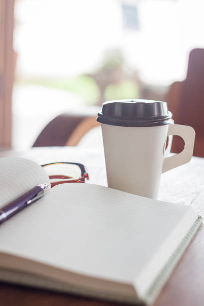 istock Close-Up Of Book And Pen With Drink On Table 912183480