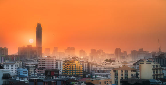Sunset cityscape with skyscrapers and slum Bangkok, Thailand.