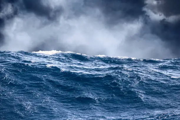 Photo of Sea wave surface close-up with storm clouds in the background