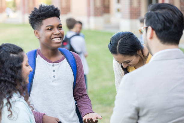 istock Group of high school friends talk with teacher 912208294