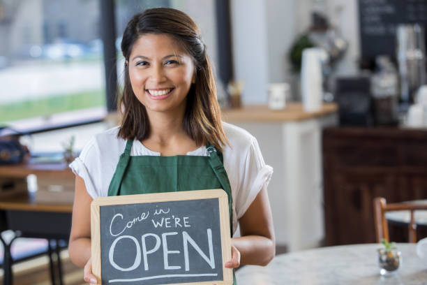 istock Confident coffee shop entrepreneur with open sign 912208636