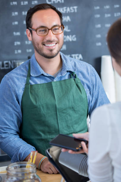 istock Woman uses mobile app to pay for coffee 912208694