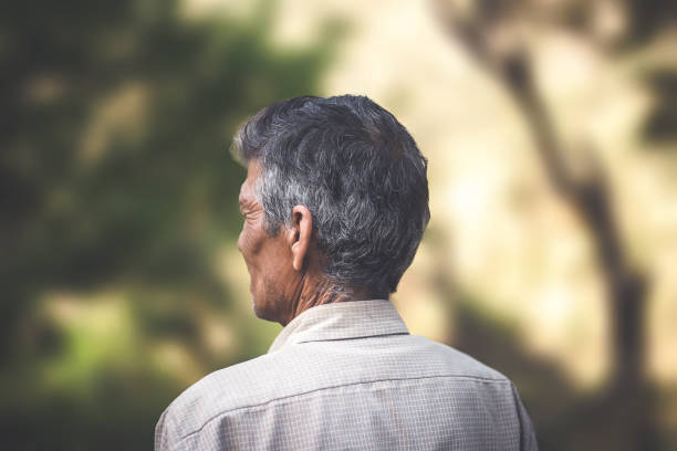 rural asian senior man thinking and looking away. - day asian ethnicity asian culture asian and indian ethnicities imagens e fotografias de stock