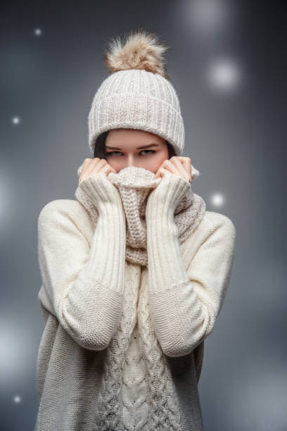 istock Young woman in white worm winter sweater. 912216038