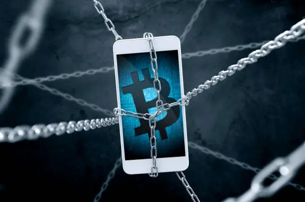 Chained smartphone with bitcoin symbol. Conception of cryptocurrency security.