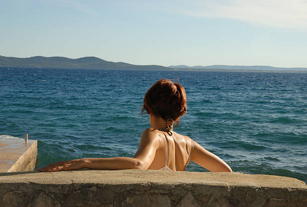 Happy young woman smiling with her eyes closed on the beach  http://azarubaika.com/iStockphoto/2012_04_07_Beach_Vacations.jpg