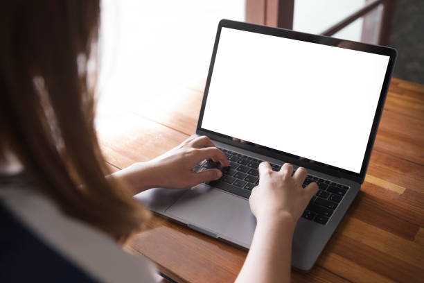 istock Women using laptop with blank screen at table in the office 912219776
