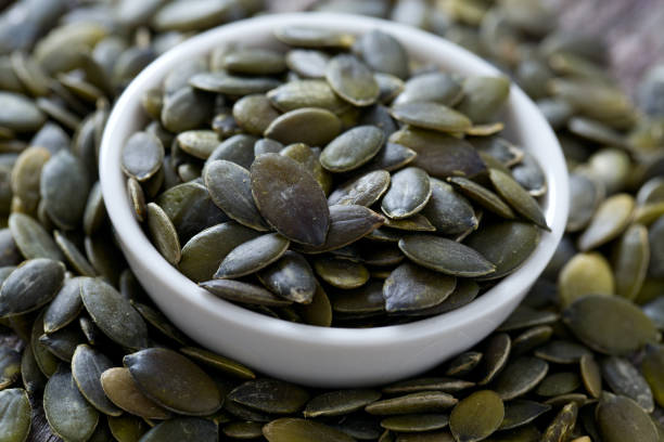 istock pumpkin seeds on wooden surface 912219862