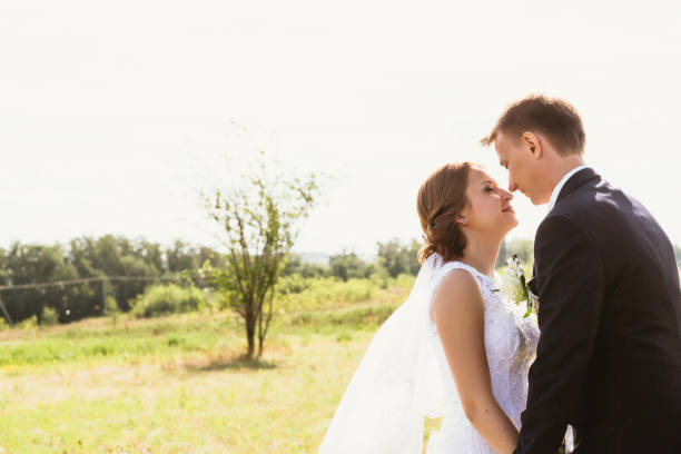 istock couple bride and groom on field background 912226292