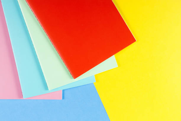 istock Colorful notebooks on blue and yellow background 912226302