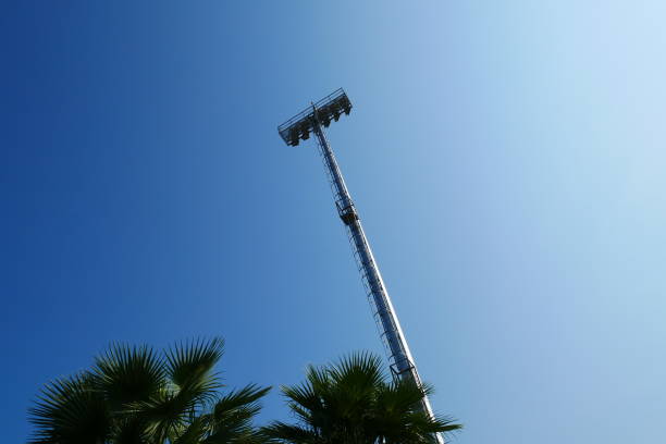 istock Spotlight on lighting tower of stadium background 912227528