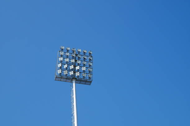 istock Spotlight on lighting tower of stadium background 912227610