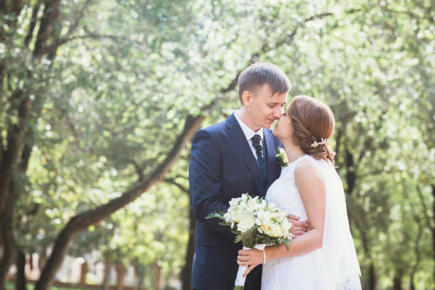 istock couple bride and groom on a park background 912227686