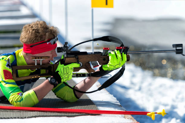istock Side View of Young Male Biathlon Competitor Practicing at Shooting Range, Lying Position 912230156