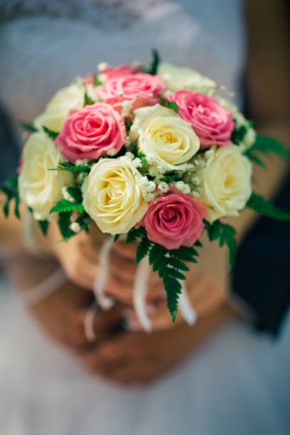 istock the bride holding a bouquet of multicolored roses 912230202