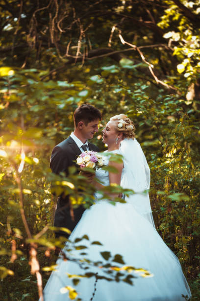 istock bride and groom on the forest background 912230868