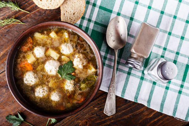 istock Soup with meatballs in a clay plate. 912234468