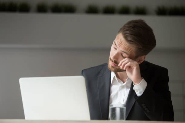 istock Overworked businessman wearing suit feeling tired from work on laptop 912234876