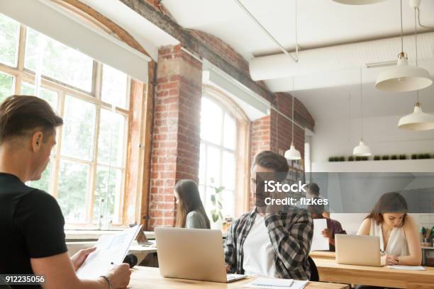 Diverse People Focused On Work In Modern Loft Coworking Space Stock Photo - Download Image Now