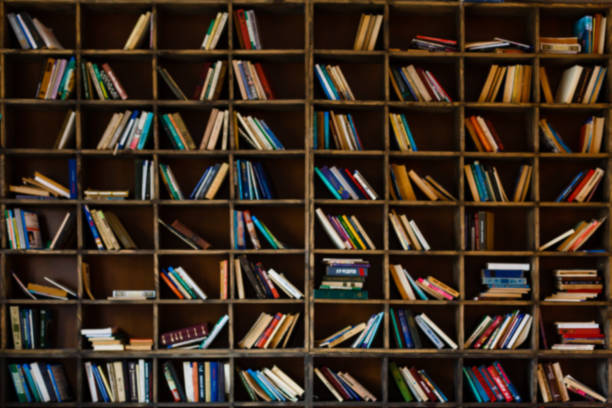 istock Blurred image many old books on bookshelf in library 912235750