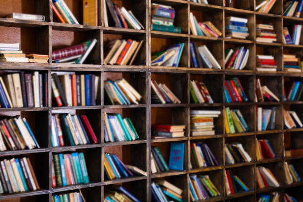 istock Bookshelf in library with many old books 912235788