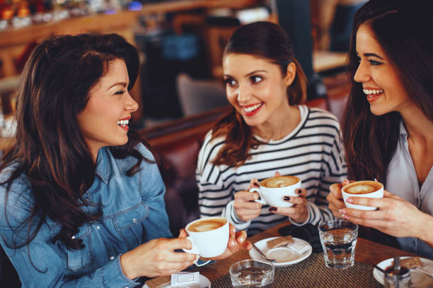istock Three young women enjoy coffee at a coffee shop 912236784