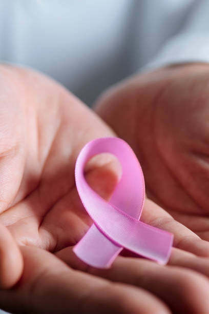 istock doctor with a pink ribbon in his hands 912239700