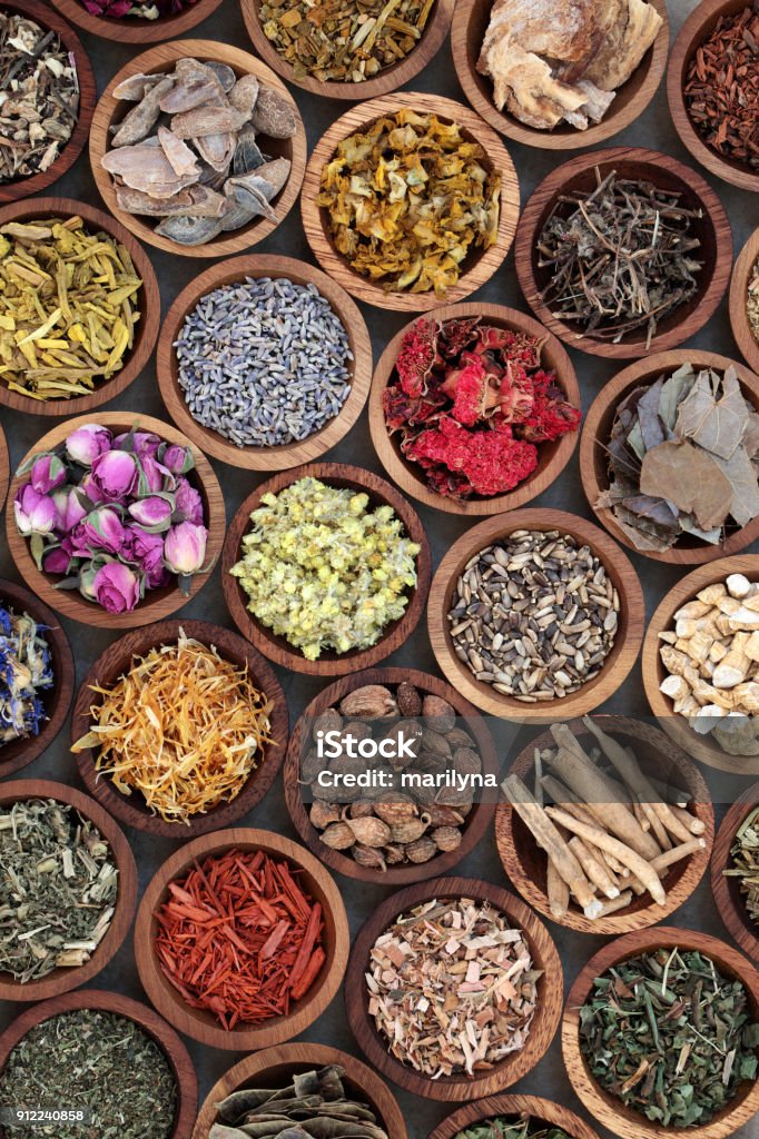 Natural Herbal Medicine Selection Natural herbal medicine selection with a variety of dried herbs and flowers in wooden bowls. Top view. Herbal Medicine Stock Photo