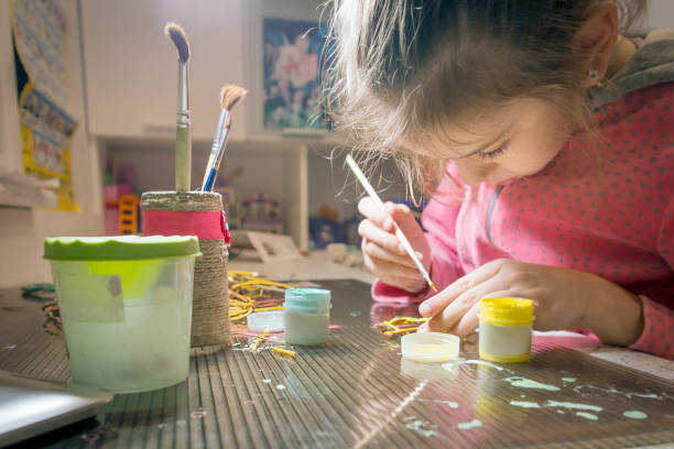 Children's creativity.The child decorates the garland.
