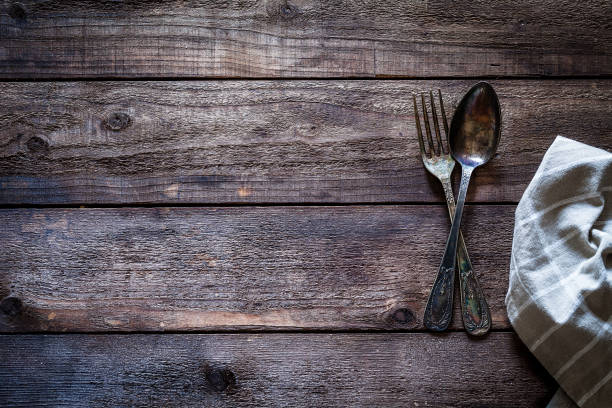 istock Vintage silverware shot from above on rustic wooden table 912243374