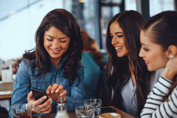 istock Three young women having fun at a coffee shop 912243376