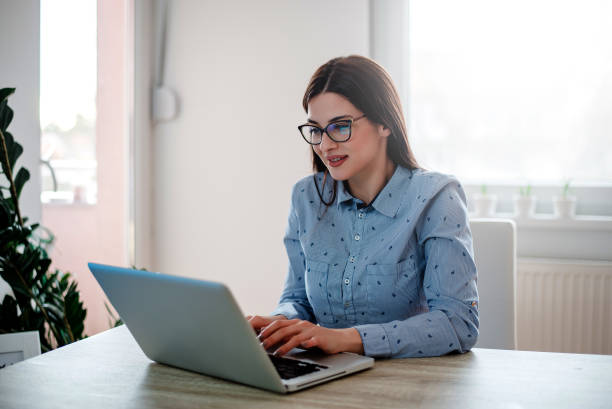istock Elegant young woman working from home office. 912243492